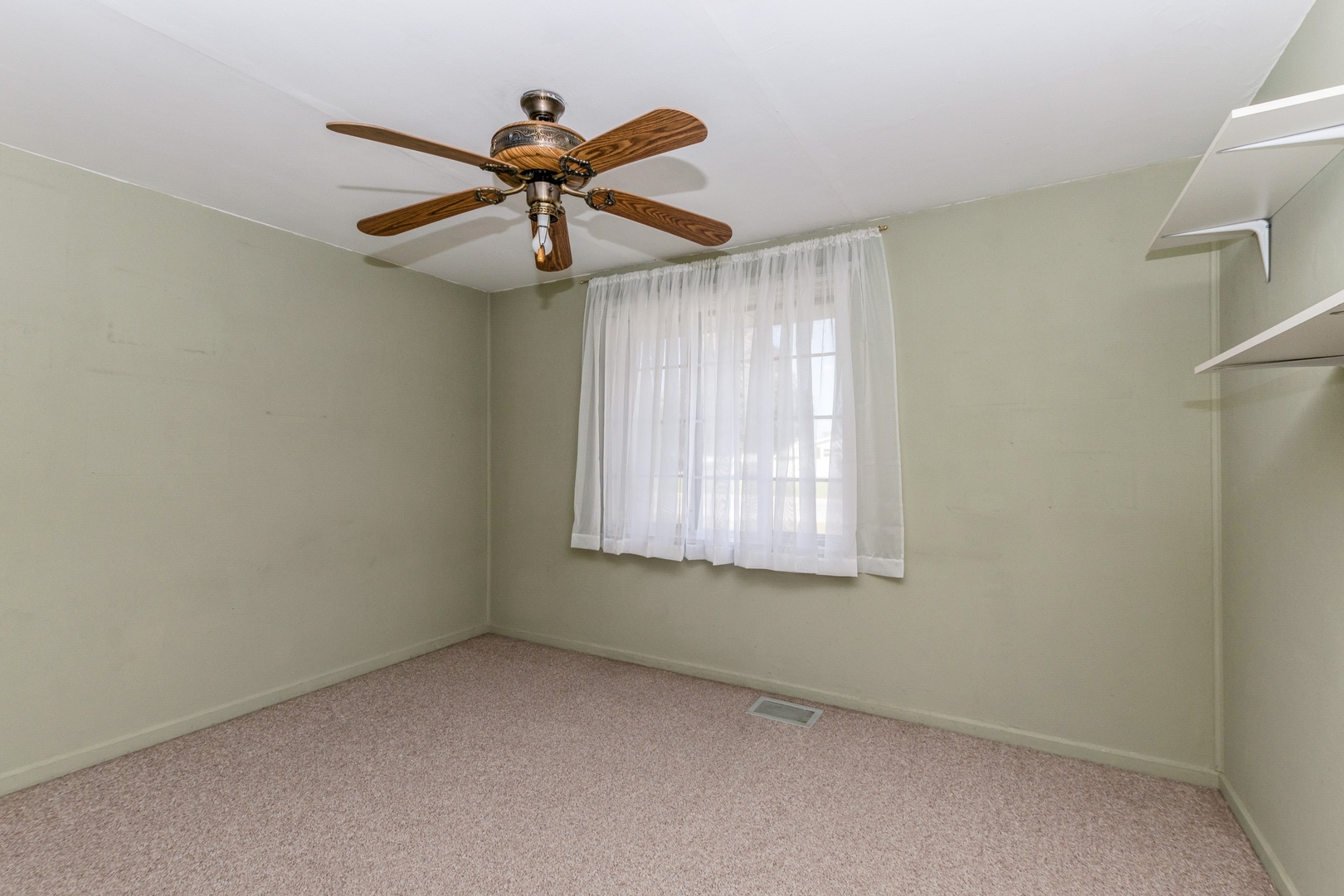 8734 South Corcoran Road Hometown, IL 60456 - Photo 8 of 15 an empty room with windows and fan