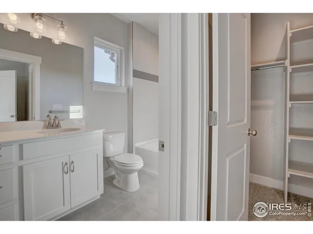 a bathroom with a sink a toilet a vanity and mirror