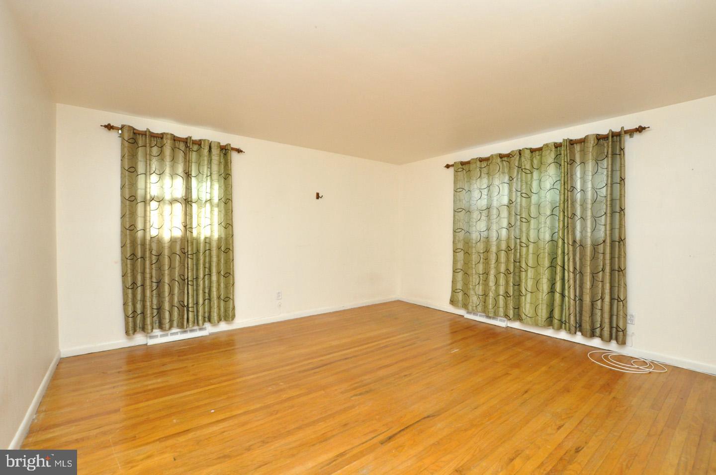 210 Philellena Road Cherry Hill, NJ 08034 - Photo 14 of 30 a view of an empty room with wooden floor and a window