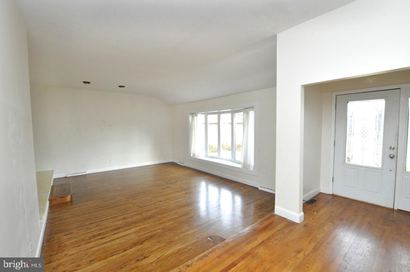 210 Philellena Road Cherry Hill, NJ 08034 - Photo 2 of 30 an empty room with wooden floor and windows