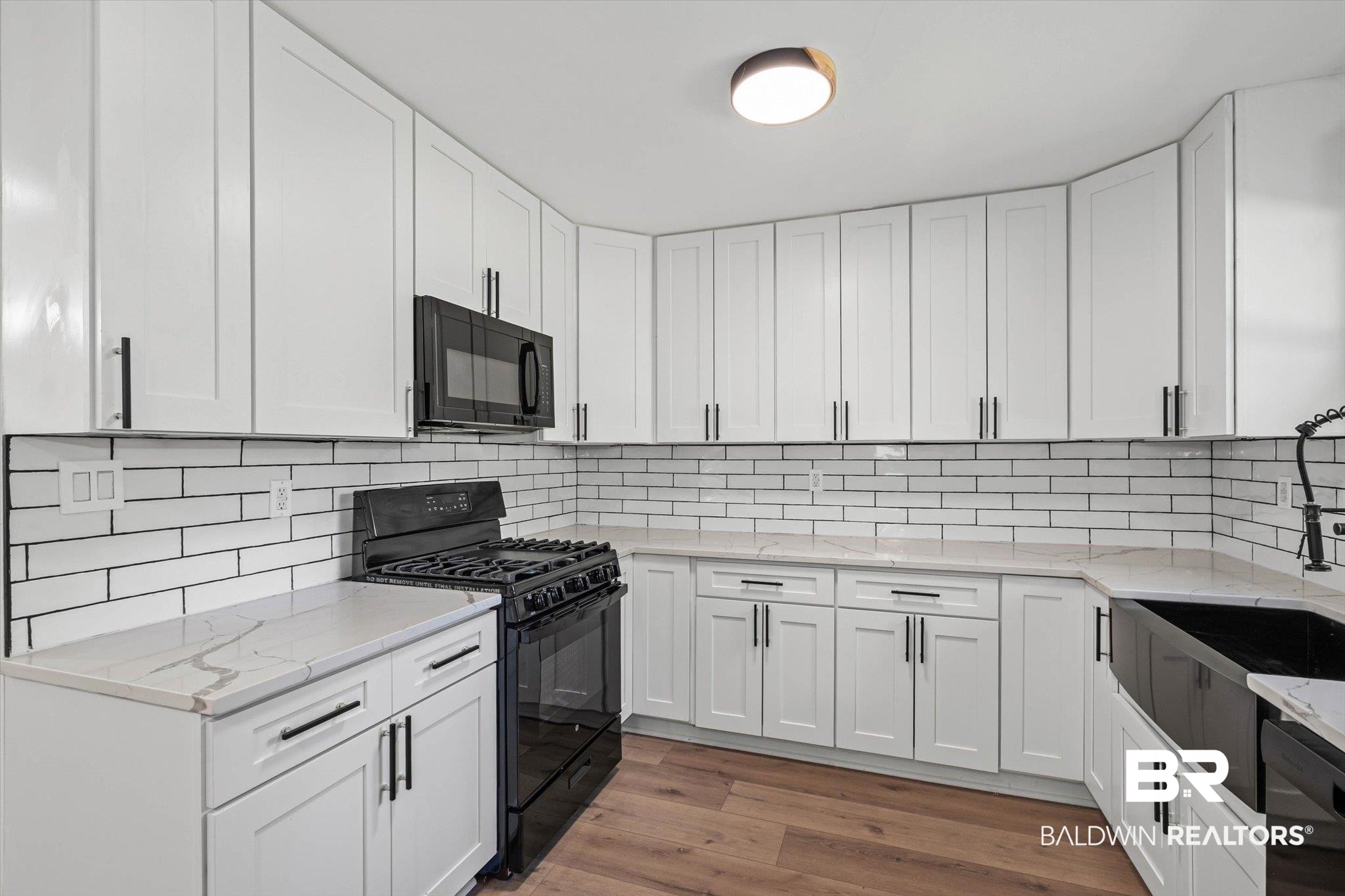 4156 Furman Drive Mobile, AL 36619 - Photo 7 of 24 Kitchen featuring black appliances, white cabinetry, and light stone countertops