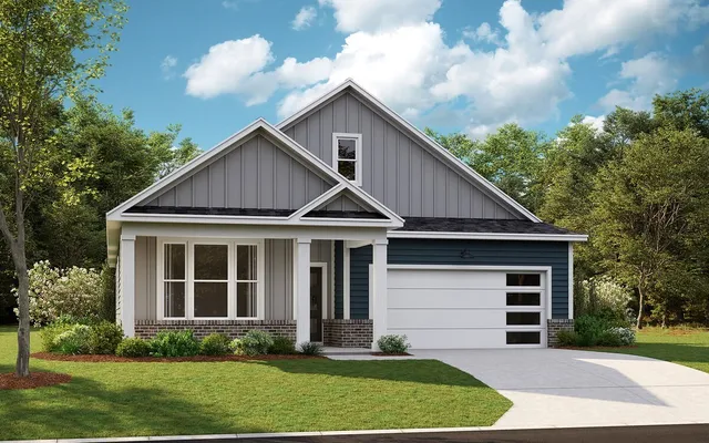 a view of a yard in front of a house with plants and large trees