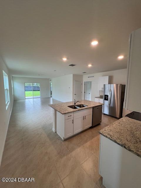 1320 Cork Drive Ormond Beach, FL 32174 - Photo 11 of 25 a large kitchen with kitchen island a sink stainless steel appliances and a counter top space