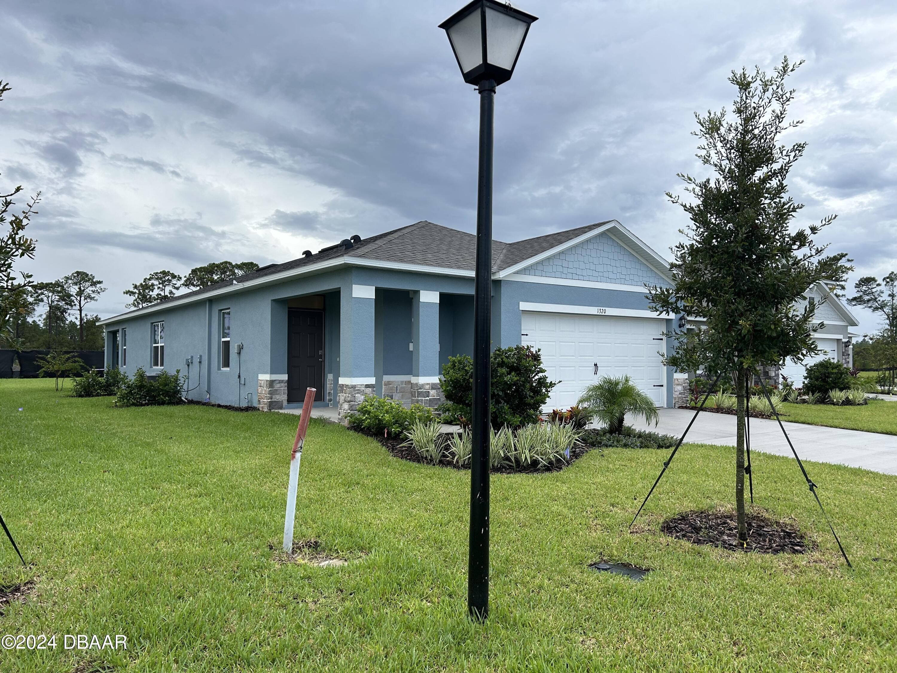 1320 Cork Drive Ormond Beach, FL 32174 - Photo 2 of 25 a view of a house with a backyard