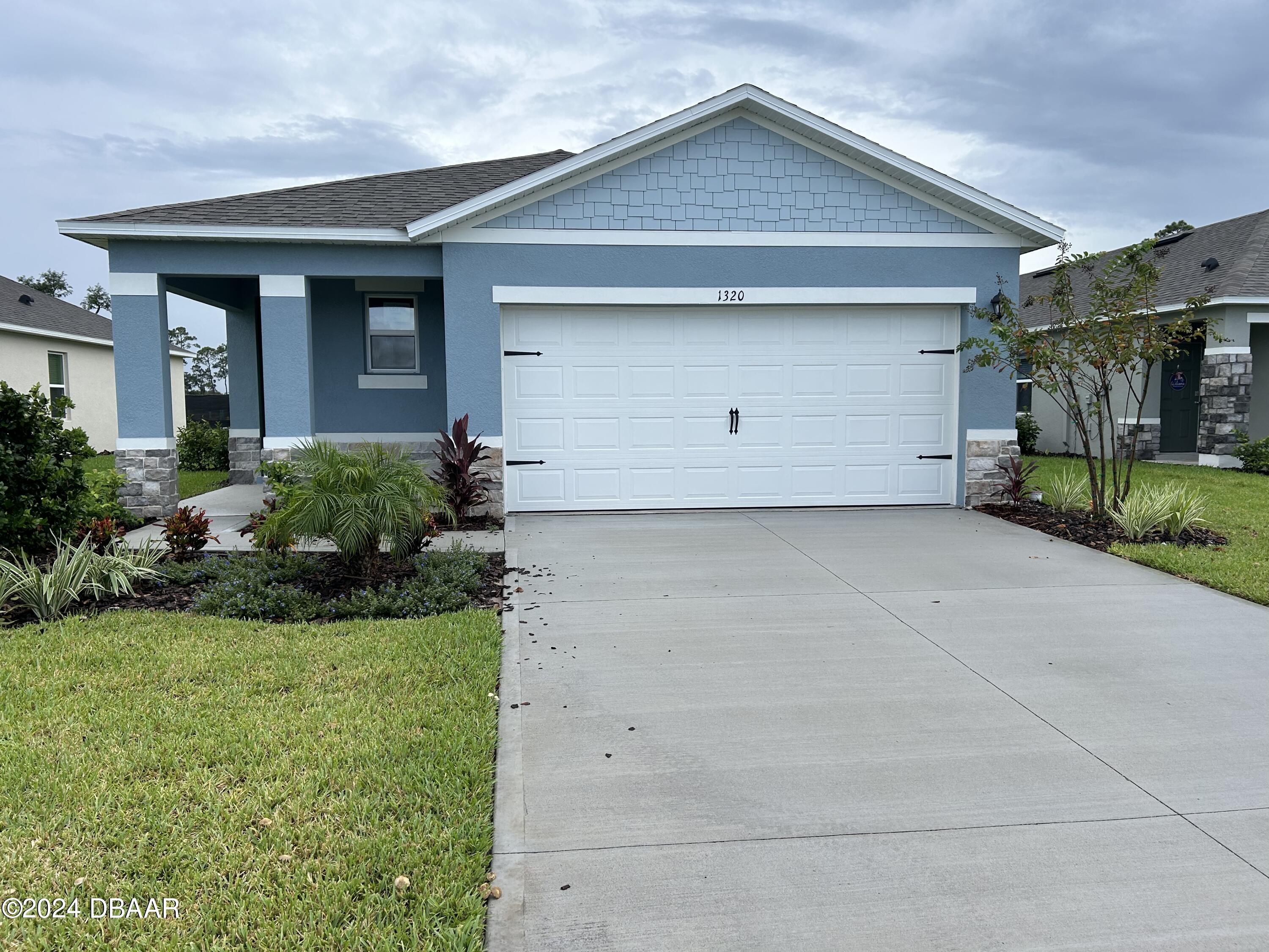 1320 Cork Drive Ormond Beach, FL 32174 - Photo 3 of 25 a front view of house with garage