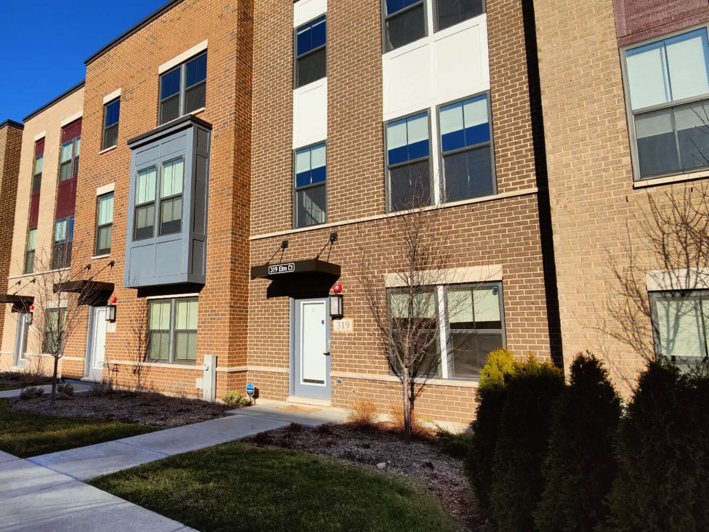 319 Elm Ct., Unit 319 Mount Prospect, IL 60056 - Photo 1 of 21 a front view of a building with a yard