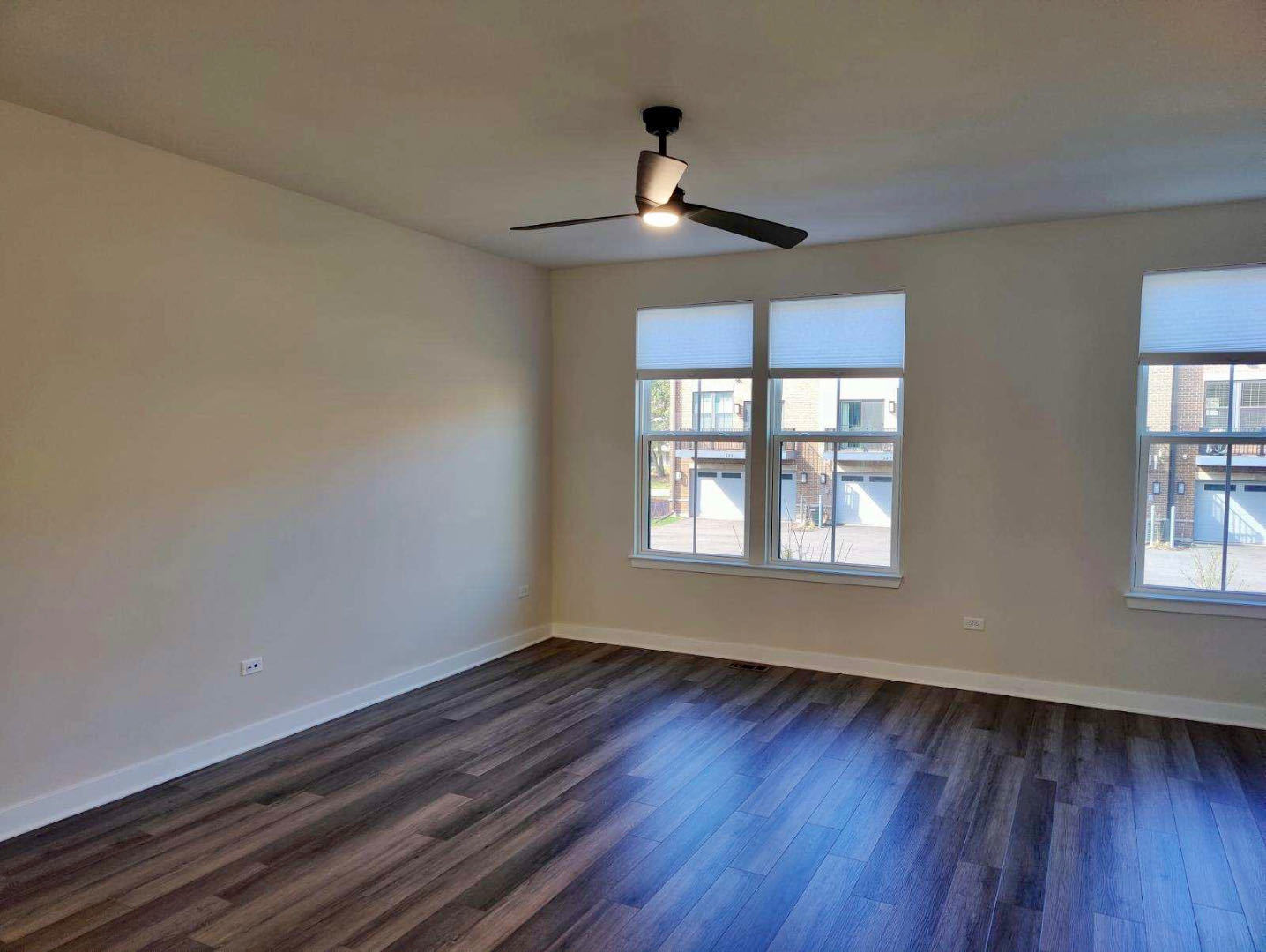 319 Elm Ct., Unit 319 Mount Prospect, IL 60056 - Photo 11 of 21 a view of an empty room with wooden floor and a window