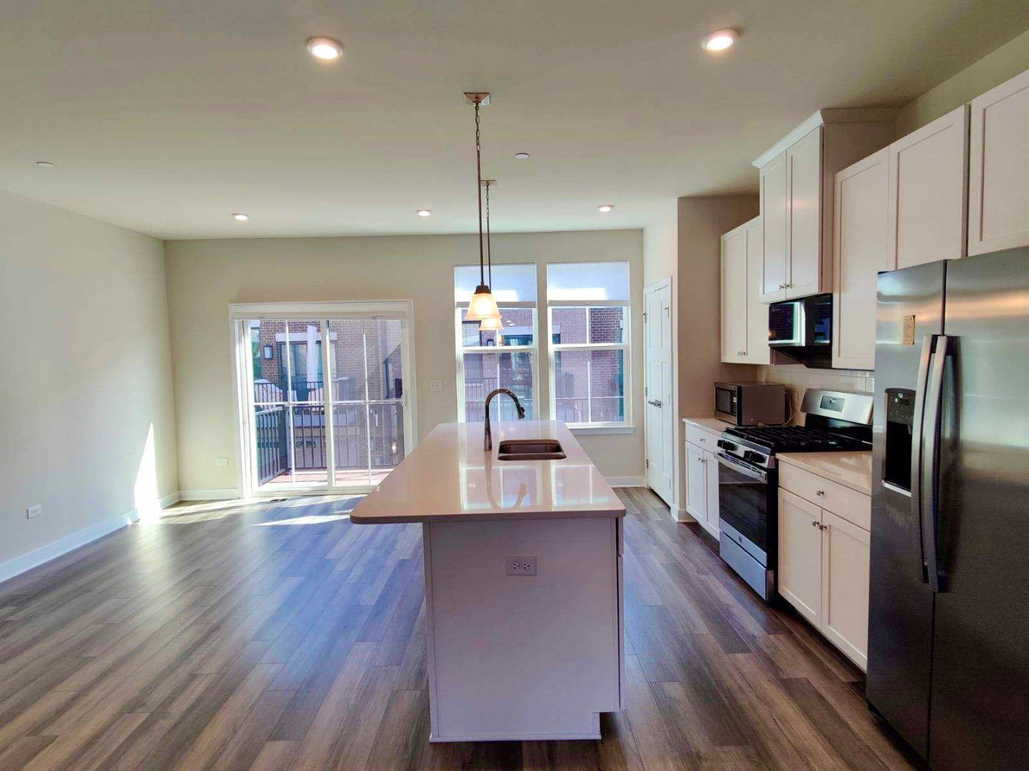 319 Elm Ct., Unit 319 Mount Prospect, IL 60056 - Photo 7 of 21 a large kitchen with stainless steel appliances granite countertop a stove a refrigerator a sink a microwave and wooden floor