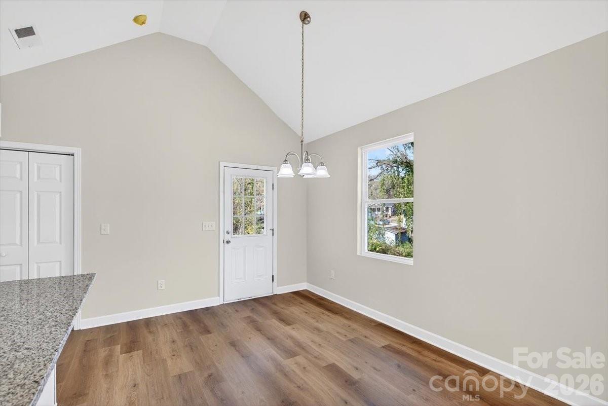 811 Craig Place Shelby, NC 28150 - Photo 12 of 28 a view of an empty room with wooden floor and a window
