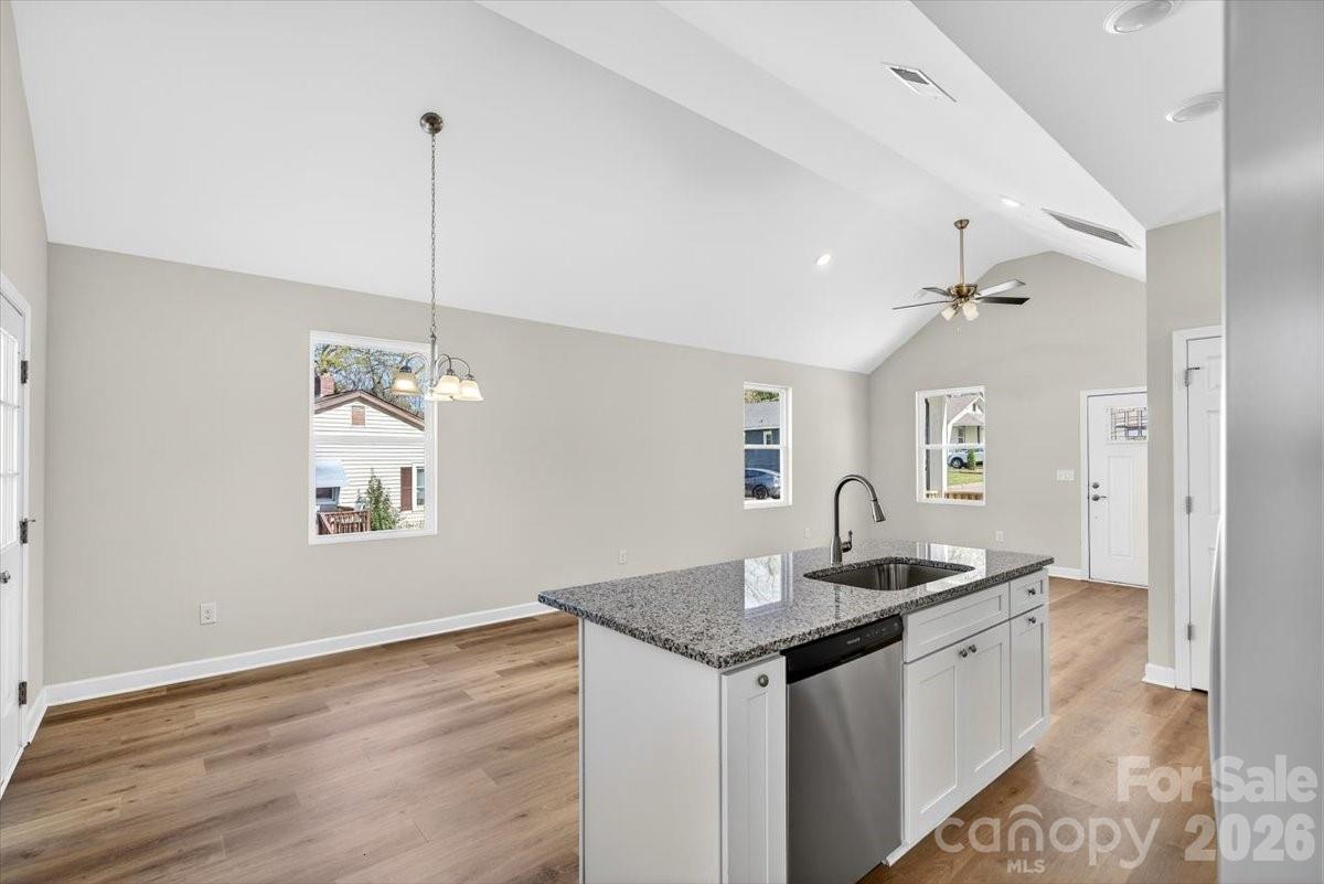 811 Craig Place Shelby, NC 28150 - Photo 15 of 28 a kitchen with granite countertop a sink cabinets and wooden floor