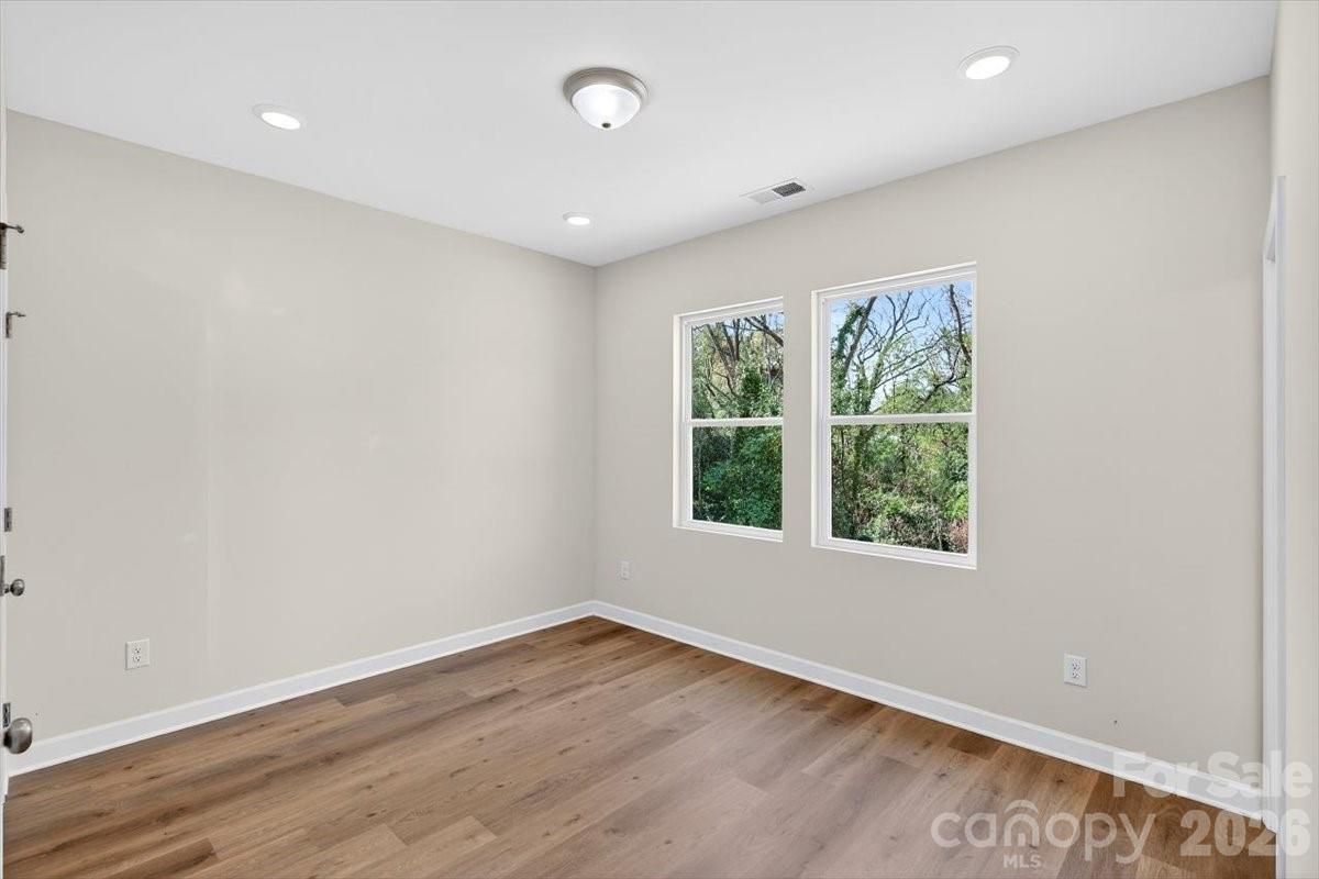 811 Craig Place Shelby, NC 28150 - Photo 18 of 28 an empty room with wooden floor and windows