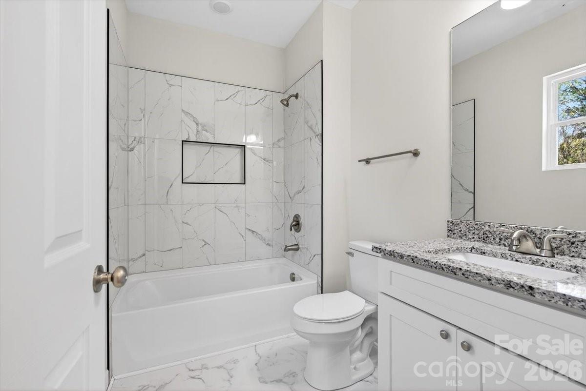 811 Craig Place Shelby, NC 28150 - Photo 19 of 28 a bathroom with a granite countertop sink toilet and shower