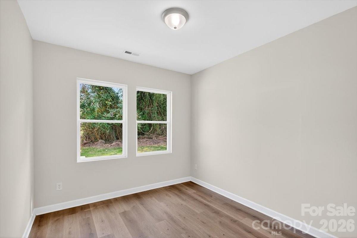 811 Craig Place Shelby, NC 28150 - Photo 20 of 28 an empty room with wooden floor and windows