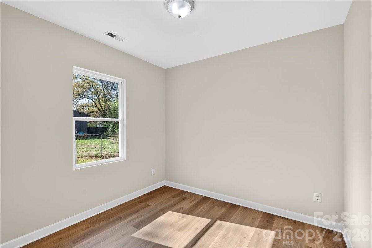 811 Craig Place Shelby, NC 28150 - Photo 22 of 28 an empty room with wooden floor and windows