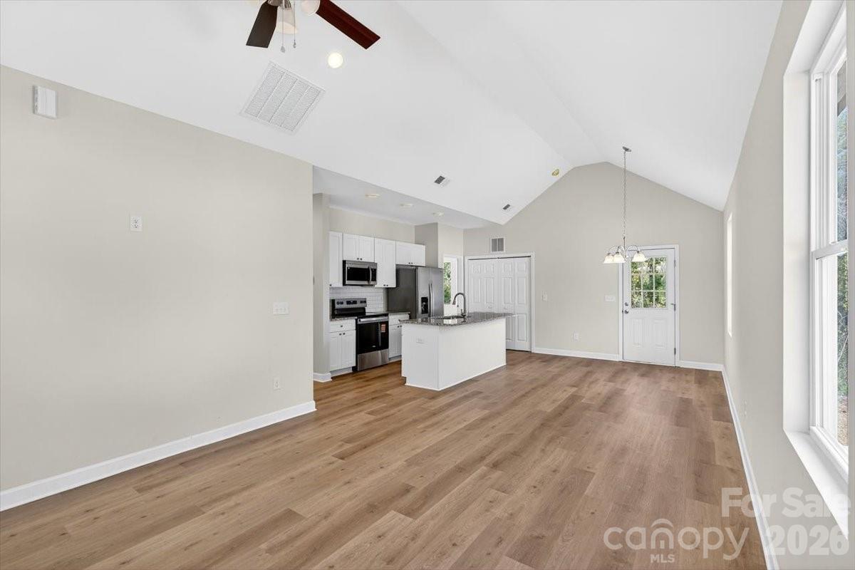 811 Craig Place Shelby, NC 28150 - Photo 5 of 28 wooden floor in an empty room with a kitchen