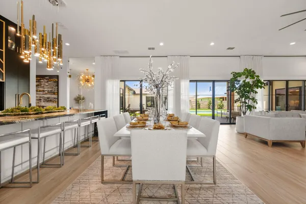 a large kitchen with a table and chairs