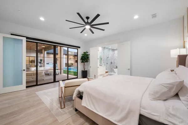 a bedroom with a large bed and a large window