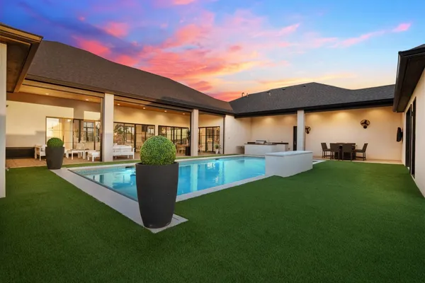 a view of a backyard with sitting area