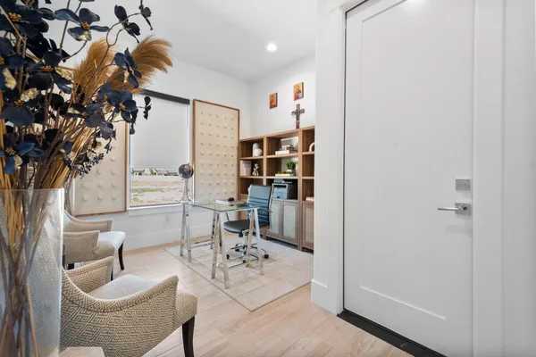 a living room with furniture and a potted plant