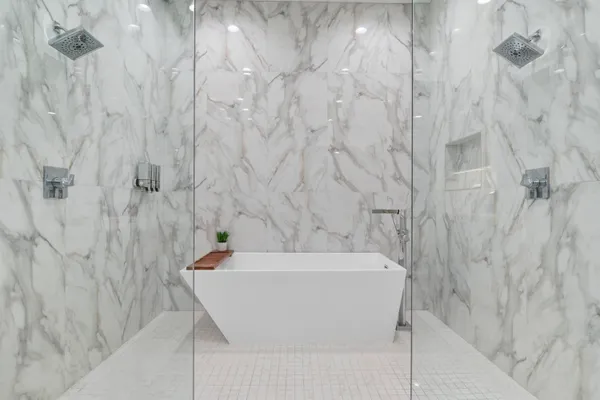 a white bath tub sitting in a bathroom