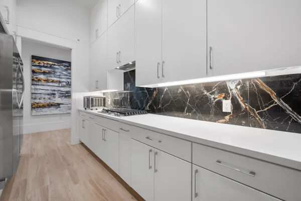 a kitchen with a sink and large window