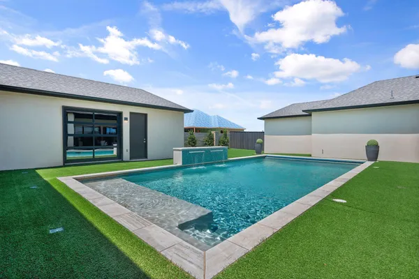 a view of an house with backyard space and garden