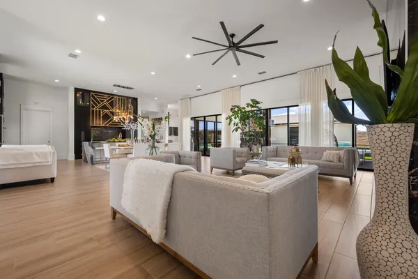 a living room with furniture a ceiling fan and a rug