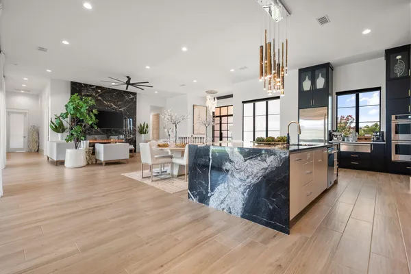 a large living room with stainless steel appliances furniture a rug and a view
