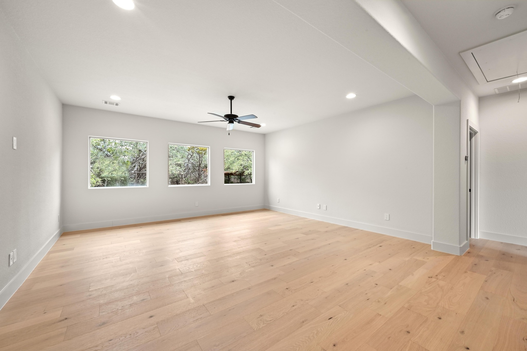 2800 Barton Point Drive Austin, TX 78733 - Photo 17 of 40 Empty room featuring light wood-style flooring, recessed lighting, and ceiling fan