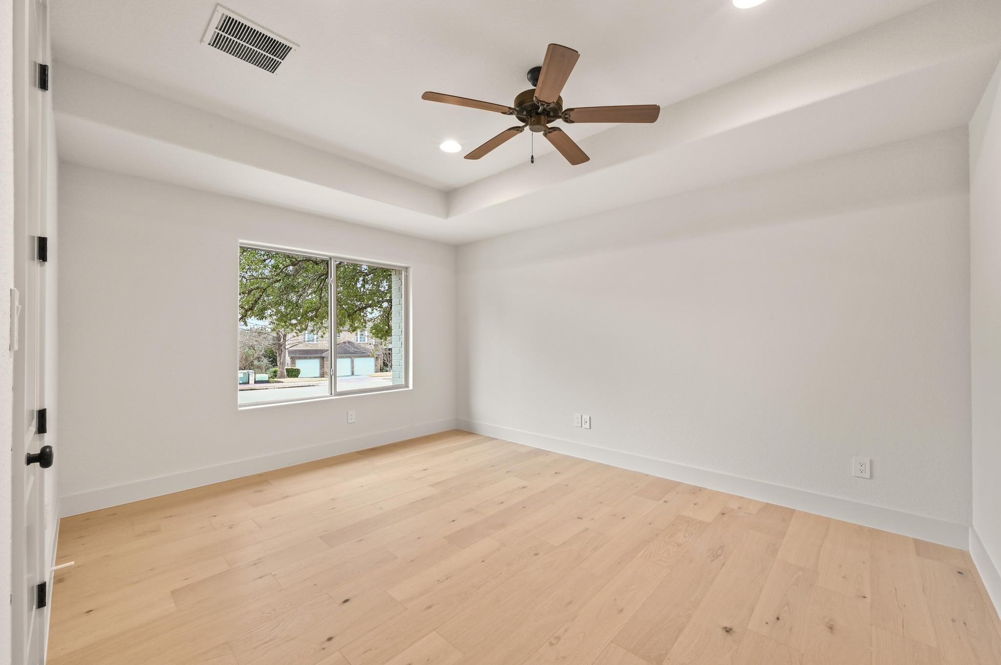 2800 Barton Point Drive Austin, TX 78733 - Photo 20 of 40 Spare room featuring a raised ceiling, recessed lighting, ceiling fan, and light wood finished floors