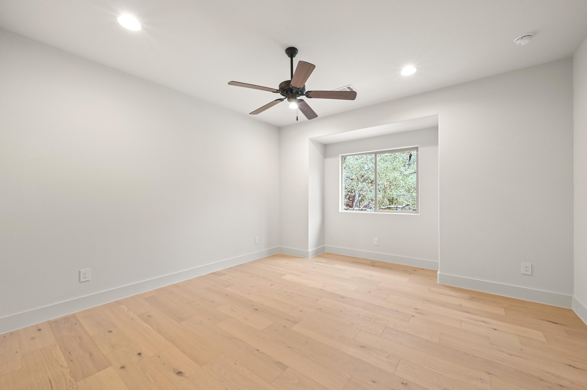 2800 Barton Point Drive Austin, TX 78733 - Photo 21 of 40 Spare room featuring ceiling fan, light wood finished floors, and recessed lighting