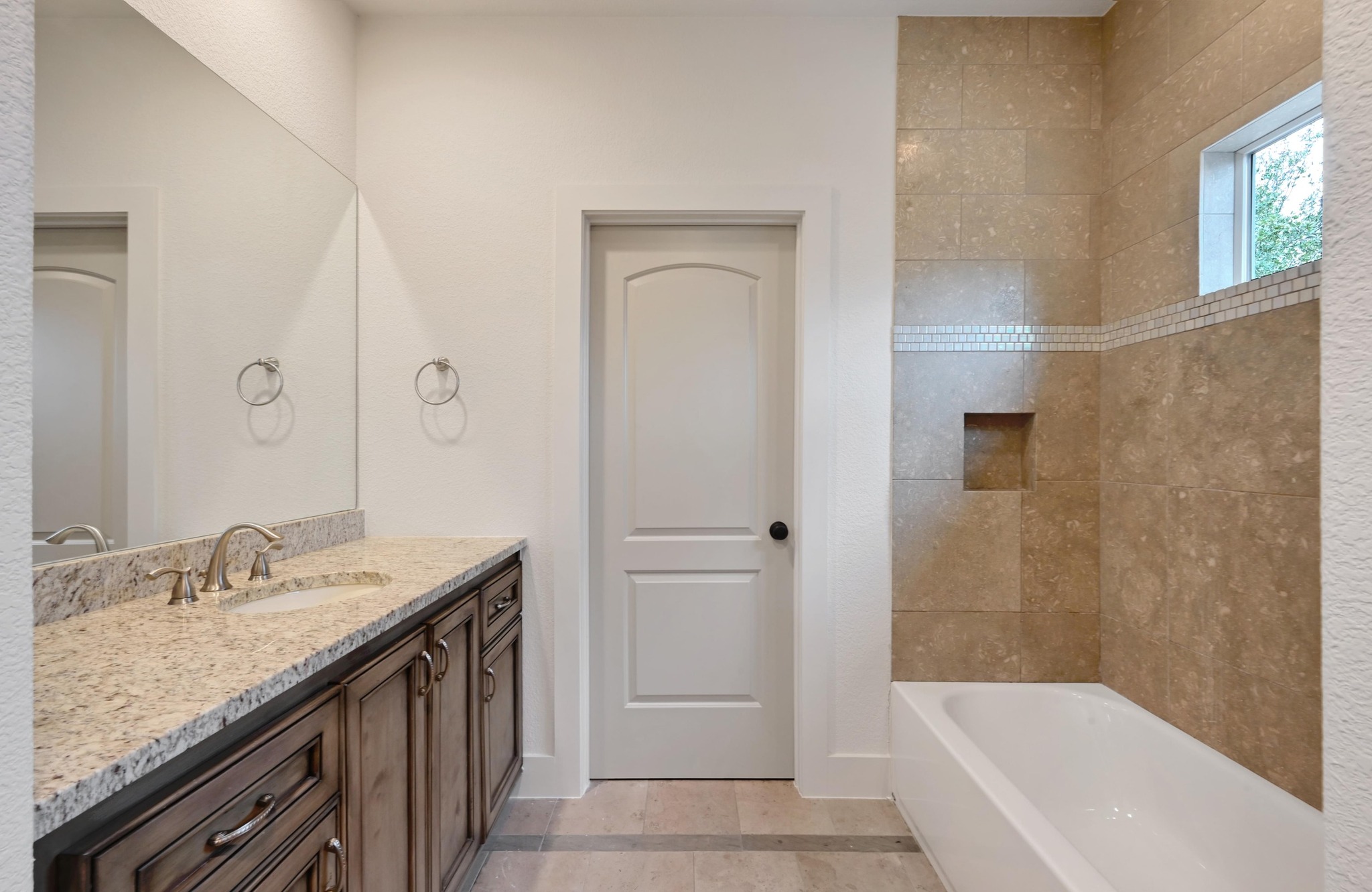 2800 Barton Point Drive Austin, TX 78733 - Photo 22 of 40 Full bathroom with vanity, light tile patterned floors, and shower / washtub combination