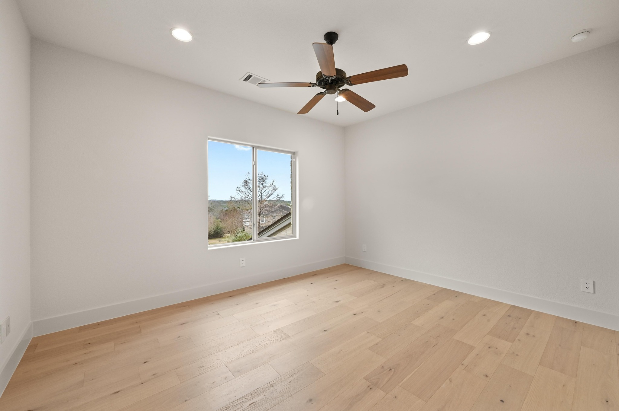 2800 Barton Point Drive Austin, TX 78733 - Photo 25 of 40 Unfurnished room with recessed lighting, light wood-style floors, and a ceiling fan