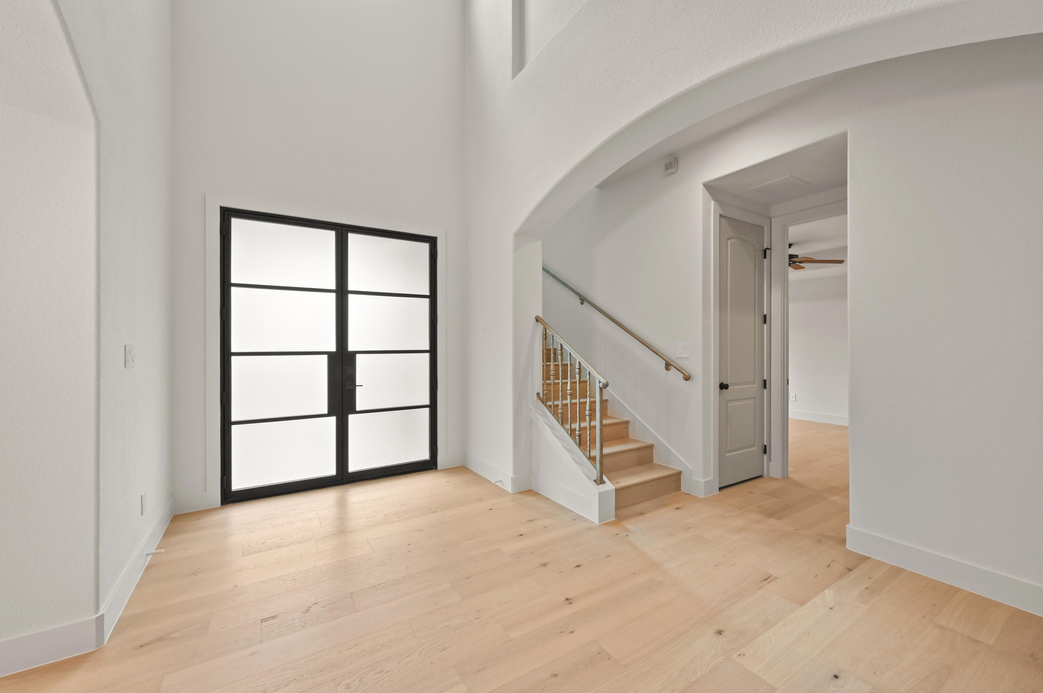2800 Barton Point Drive Austin, TX 78733 - Photo 3 of 40 Foyer with arched walkways, a high ceiling, light wood-style floors, and ceiling fan