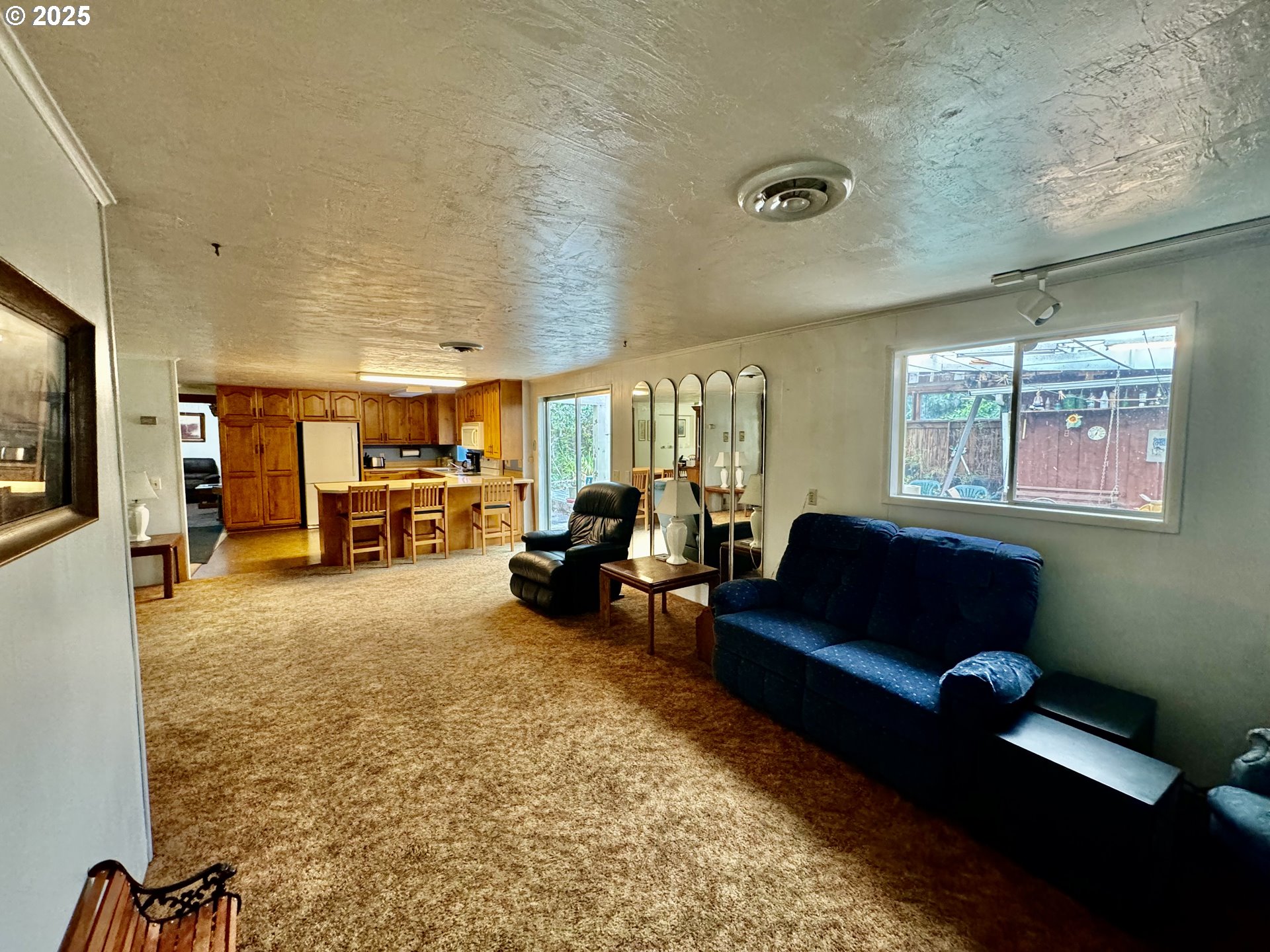4990 Mitchell Loop Road Florence, OR 97439 - Photo 19 of 35 a living room with furniture gym equipment and a flat screen tv
