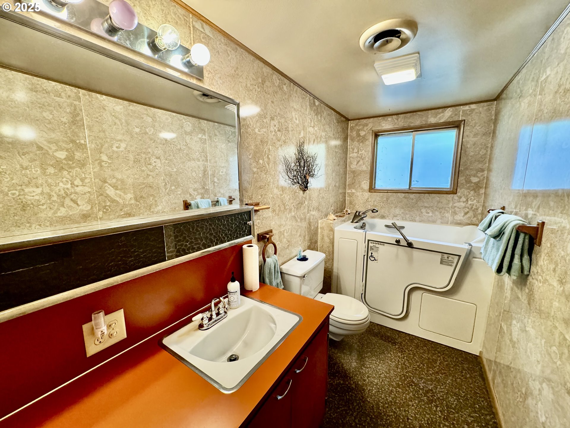 4990 Mitchell Loop Road Florence, OR 97439 - Photo 23 of 35 a bathroom with a sink a mirror and a bathtub