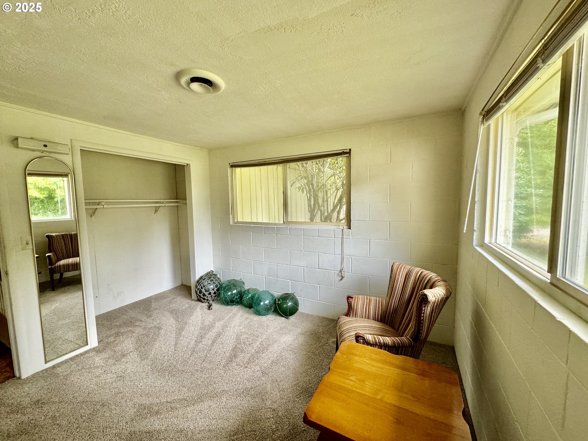 4990 Mitchell Loop Road Florence, OR 97439 - Photo 27 of 35 a living room with furniture and a window