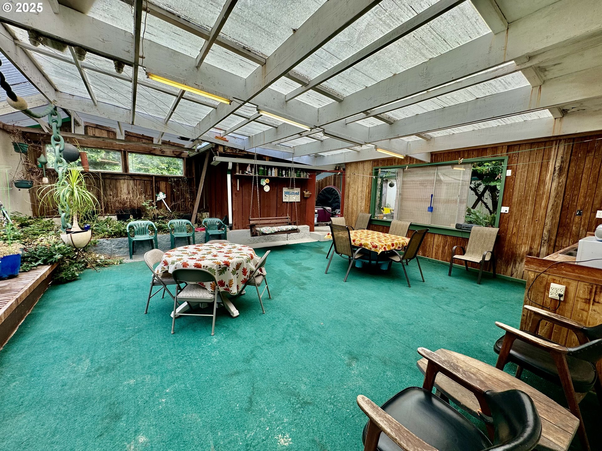 4990 Mitchell Loop Road Florence, OR 97439 - Photo 28 of 35 a backyard of a house with garden and outdoor seating