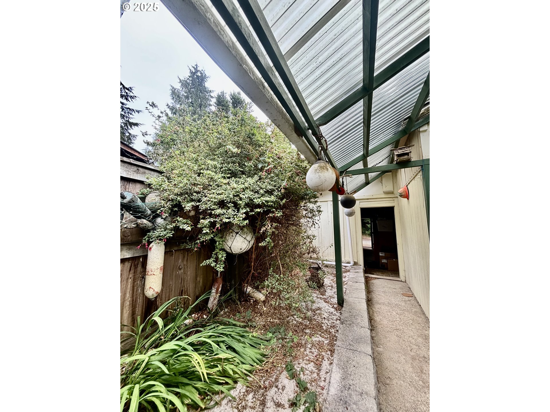 4990 Mitchell Loop Road Florence, OR 97439 - Photo 31 of 35 a backyard of a house with lots of green space