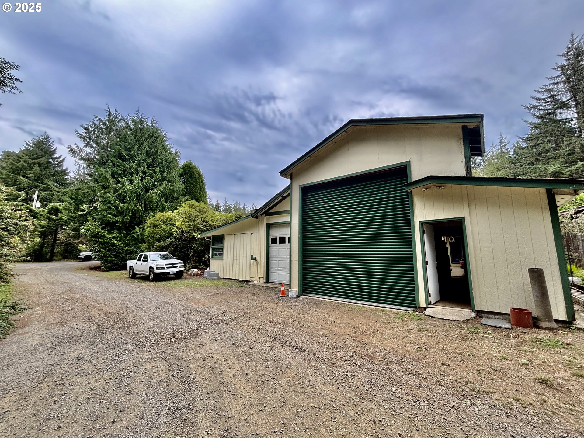 4990 Mitchell Loop Road Florence, OR 97439 - Photo 33 of 35 a view of a house with a yard and garage
