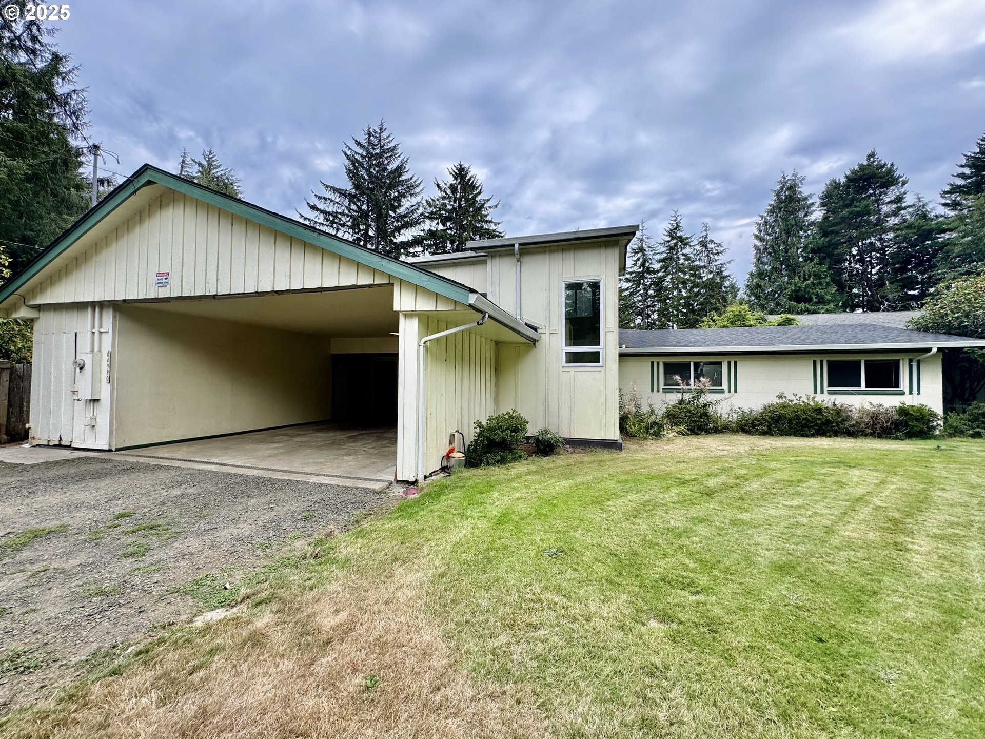 4990 Mitchell Loop Road Florence, OR 97439 - Photo 35 of 35 a front view of a house with a yard and garage