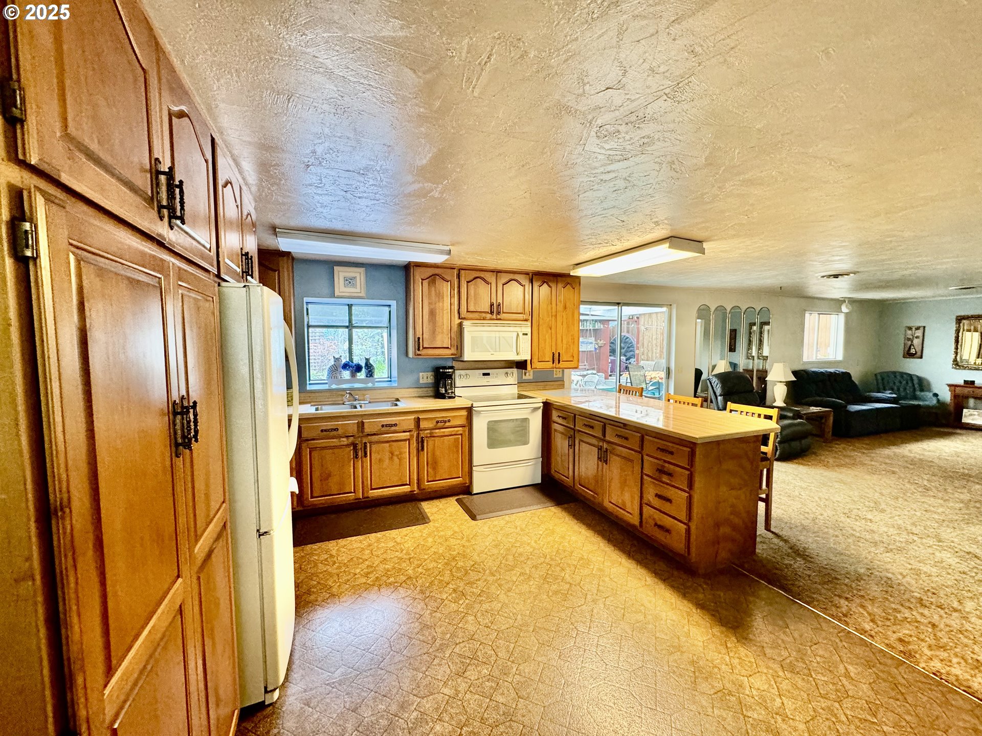 4990 Mitchell Loop Road Florence, OR 97439 - Photo 9 of 35 a kitchen with stainless steel appliances a refrigerator and a stove