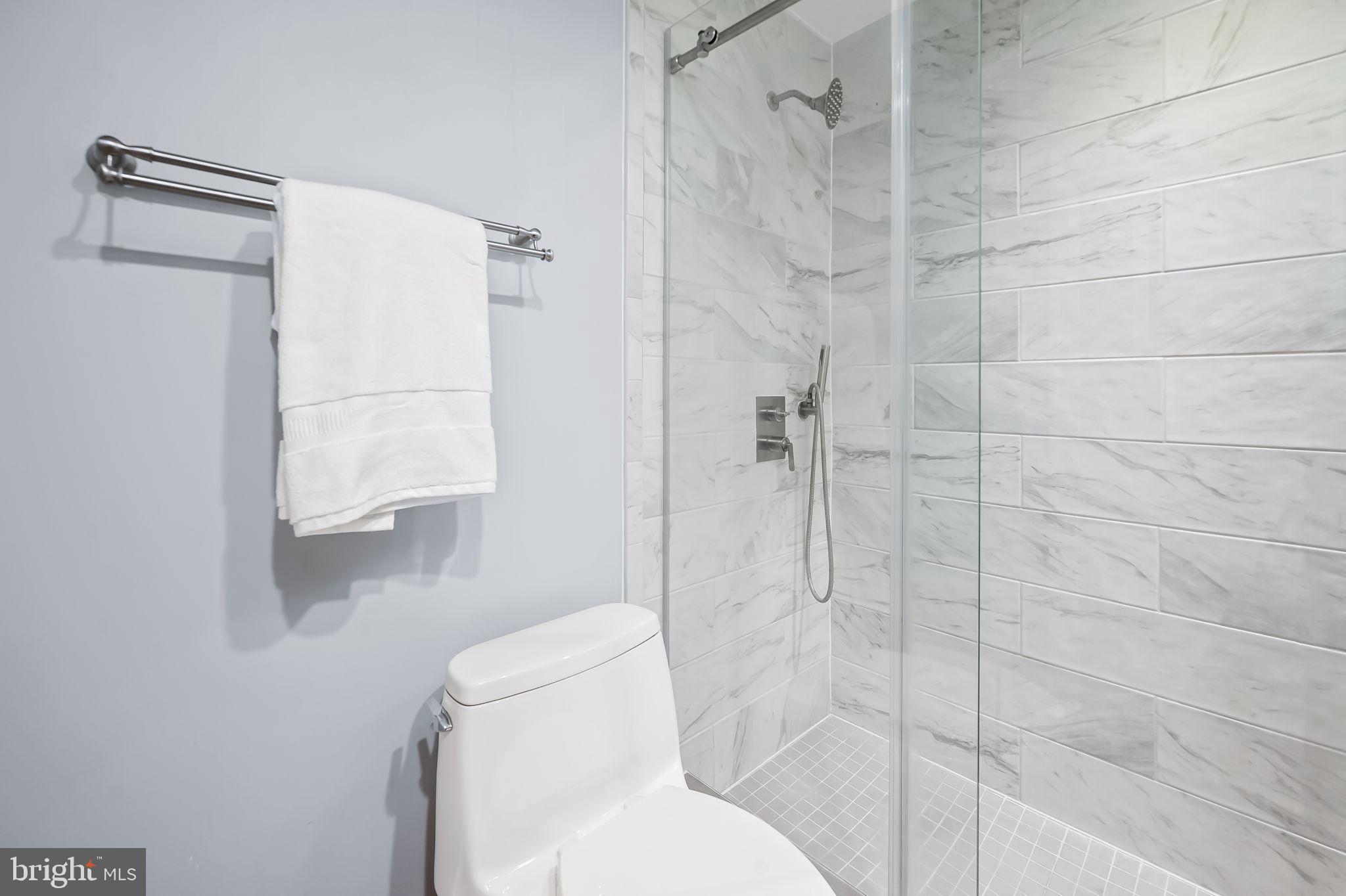 612 Pubped Way Baltimore, MD 21230 - Photo 28 of 55 a white toilet sitting next to a bathroom shower