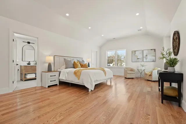 a bedroom with furniture and a wooden floor