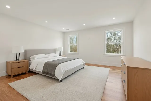 a spacious bedroom with a bed and a couch