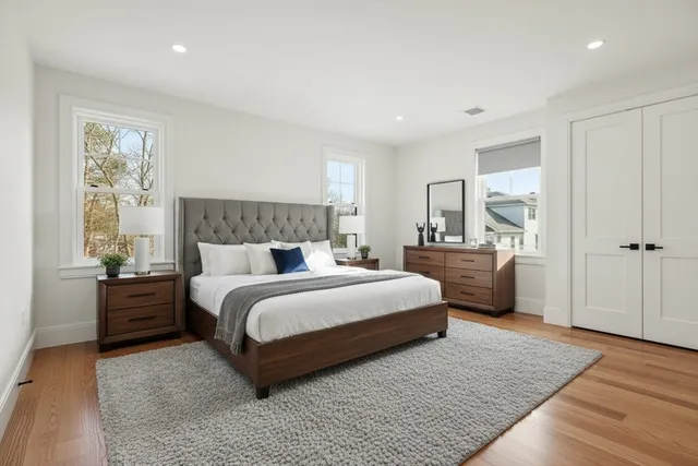 a spacious bedroom with a bed and a couch