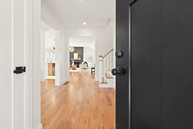a view of a hallway with wooden floor windows and livingroom