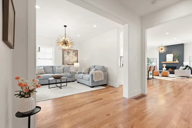 a living room with furniture and a chandelier