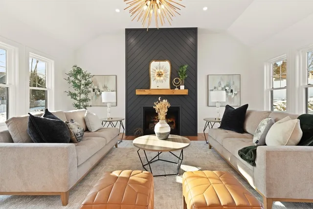 a living room with furniture and a fireplace