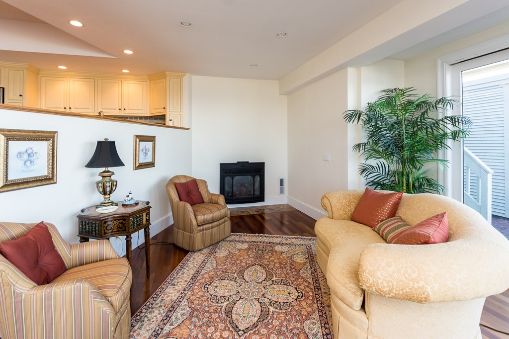 63 Oceanside Drive, Unit 63 Hull, MA 02045 - Photo 13 of 30 a living room with furniture and a large window